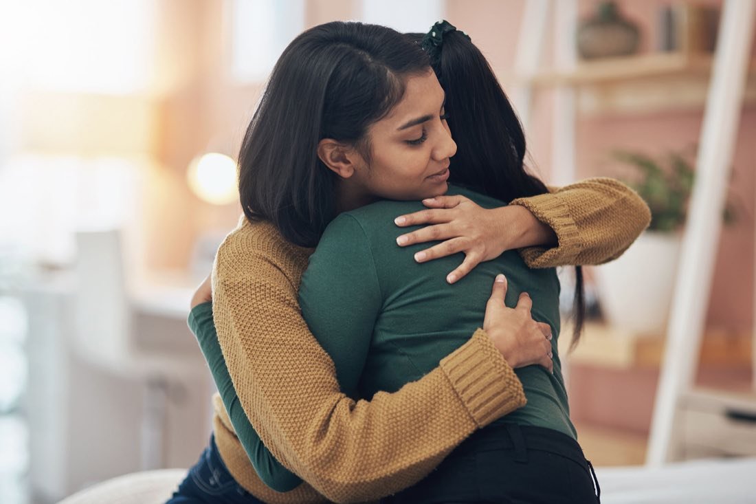 A parent holding their child close