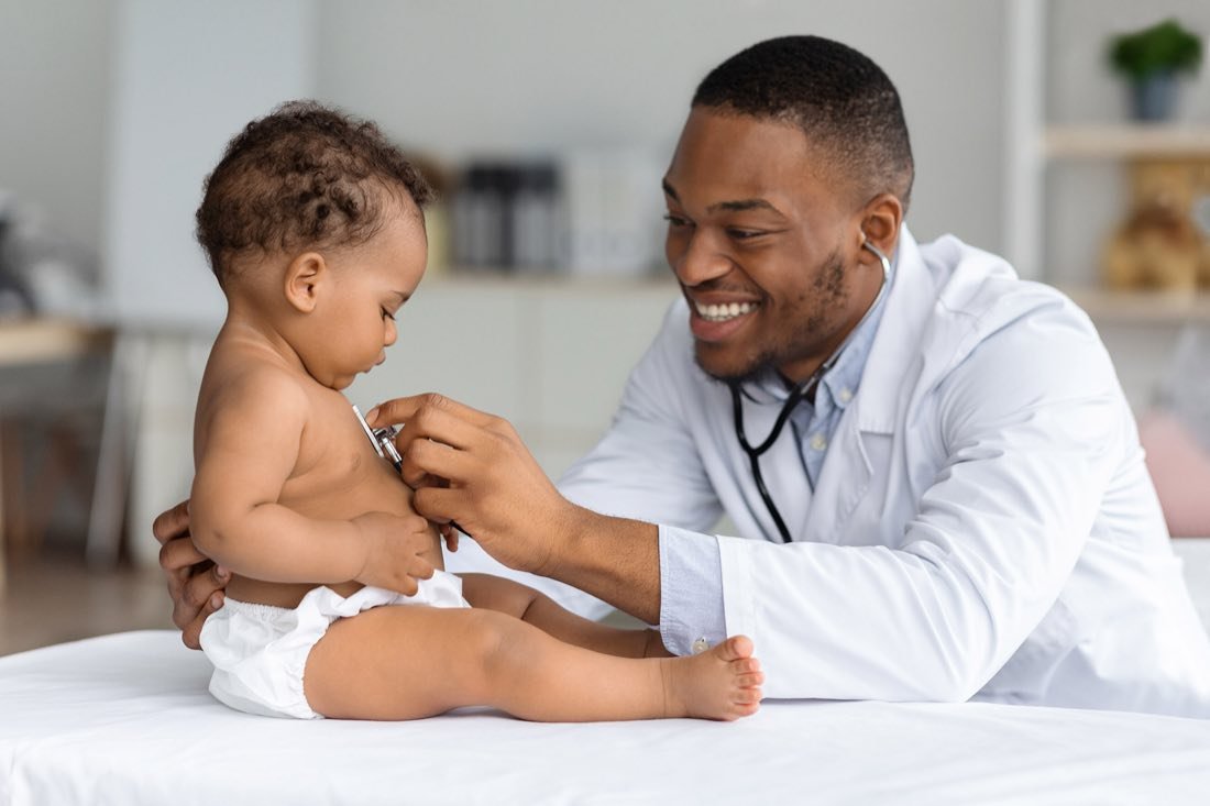 A clinician performing a pediatric heart screening