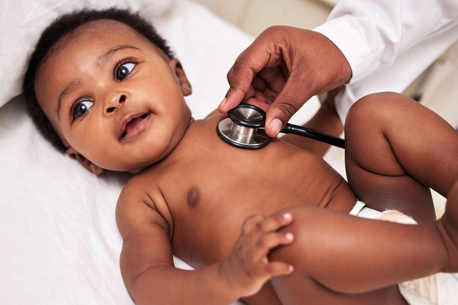 A doctor listening to a baby's heart with a stethoscope